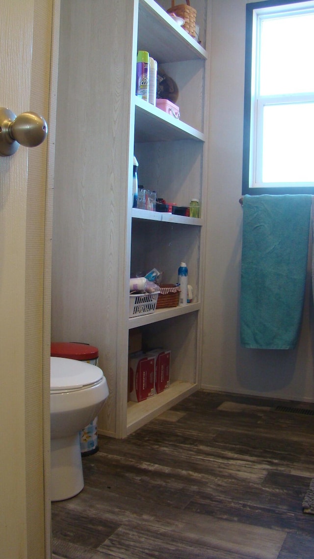 bathroom featuring hardwood / wood-style flooring and toilet