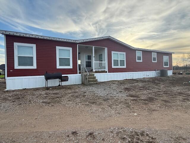 view of front of house featuring cooling unit and covered porch