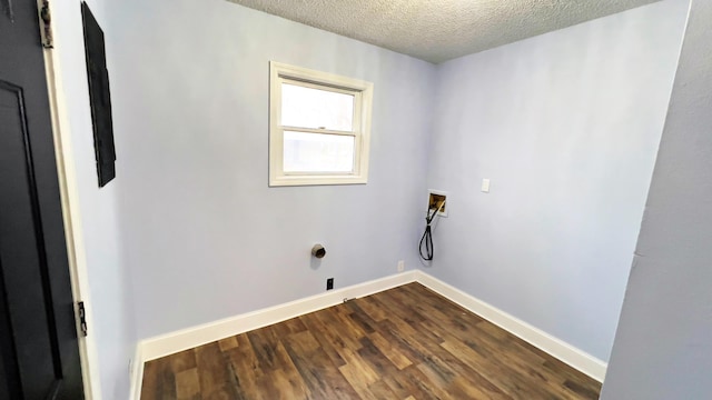 clothes washing area with washer hookup, a textured ceiling, and wood-type flooring