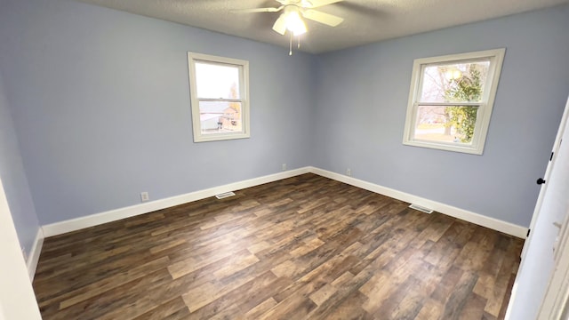 unfurnished room with a textured ceiling, ceiling fan, and dark wood-type flooring