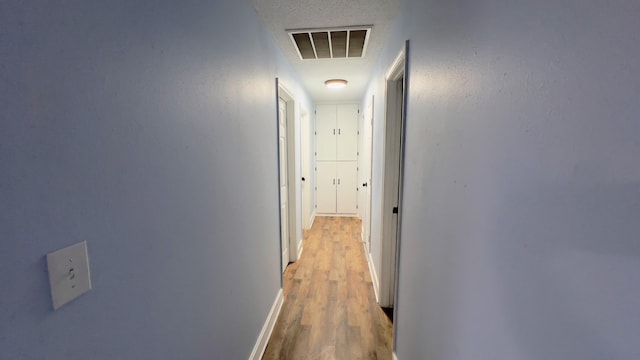 corridor with light wood-type flooring