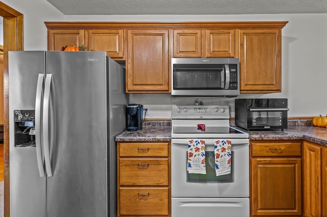 kitchen featuring a textured ceiling and appliances with stainless steel finishes