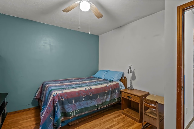 bedroom featuring ceiling fan and wood-type flooring