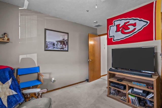 carpeted living room featuring a textured ceiling