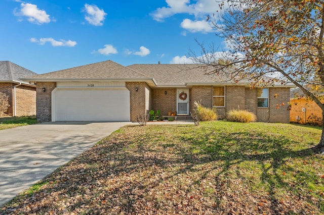 ranch-style house with a garage and a front yard