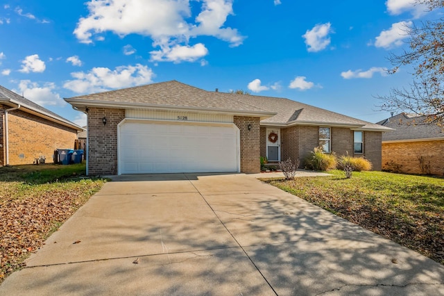 ranch-style house featuring a front yard and a garage