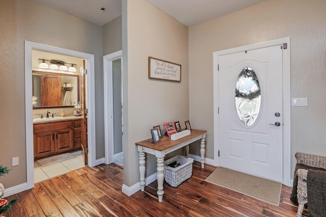 entrance foyer featuring baseboards and wood finished floors