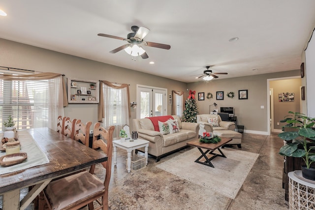 living area featuring ceiling fan, concrete flooring, recessed lighting, baseboards, and french doors