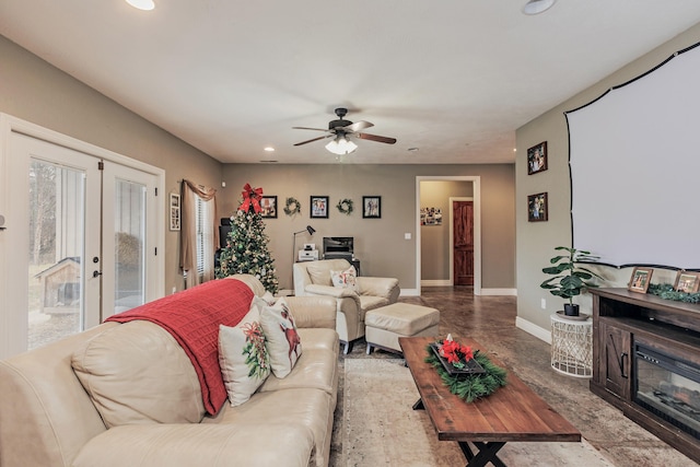 living room featuring french doors, recessed lighting, a glass covered fireplace, ceiling fan, and baseboards