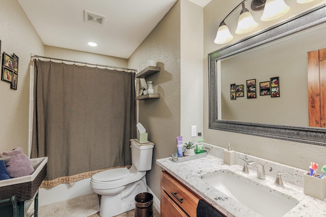 full bathroom with visible vents, a textured wall, vanity, and toilet