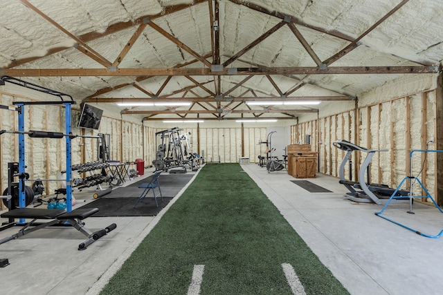 exercise room with vaulted ceiling and a garage