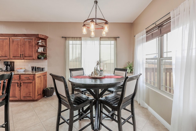 dining area with light tile patterned flooring and baseboards