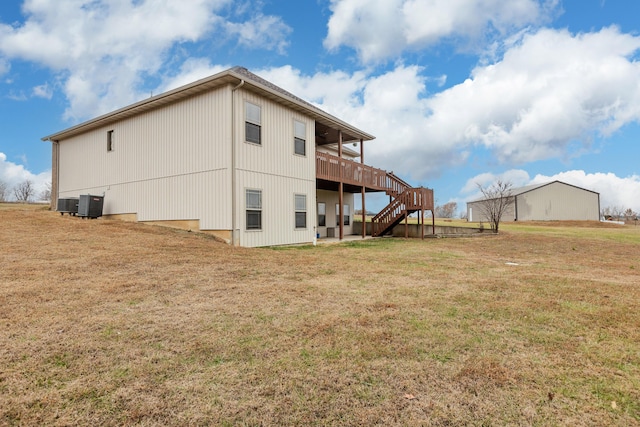 back of property featuring stairs, a yard, a deck, and central air condition unit