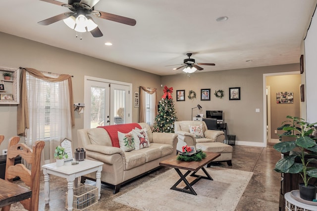 living area featuring baseboards, ceiling fan, concrete flooring, french doors, and recessed lighting