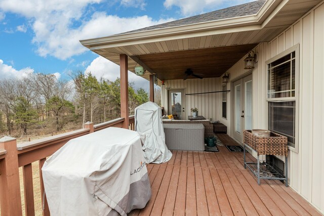 wooden terrace with an outdoor hangout area and a ceiling fan