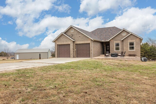 ranch-style house with a garage, a front lawn, concrete driveway, and brick siding