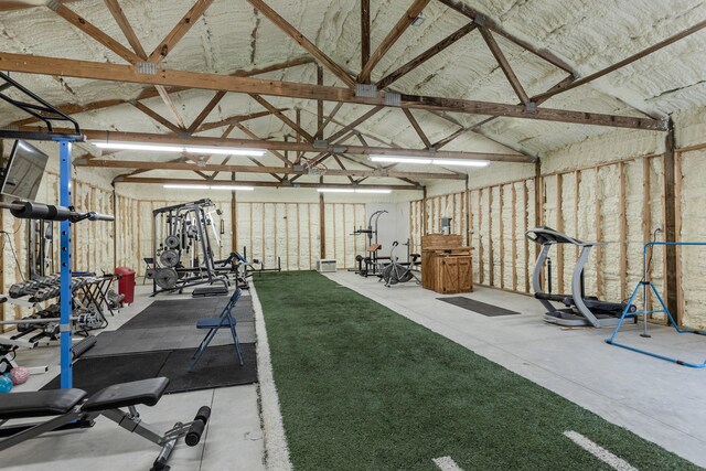 interior space with a garage and vaulted ceiling