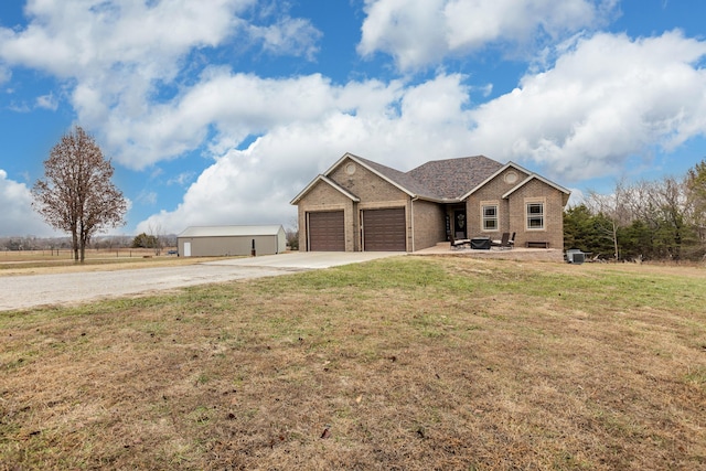 view of front facade featuring an attached garage, a front lawn, concrete driveway, and brick siding