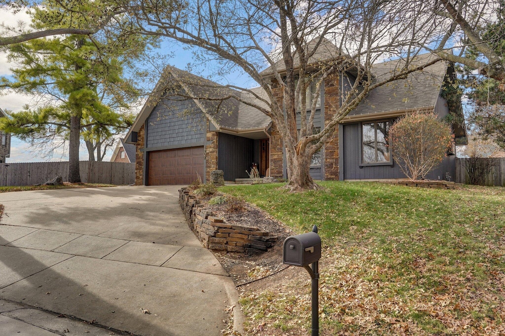 view of front of property with a garage and a front lawn