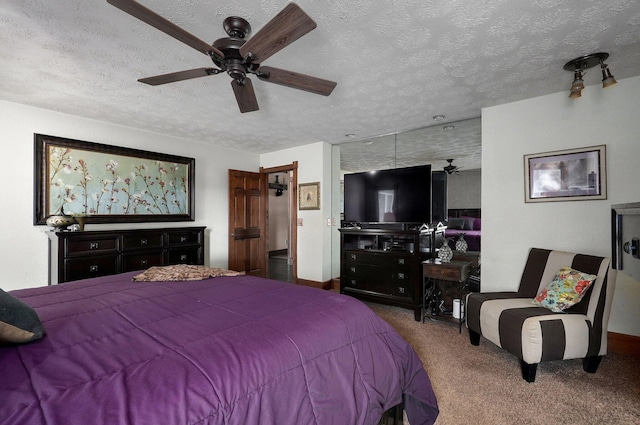 bedroom with carpet flooring, a textured ceiling, and ceiling fan