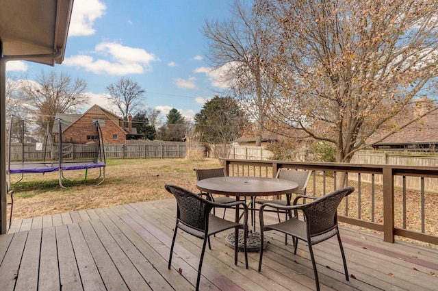 wooden terrace featuring a yard and a trampoline