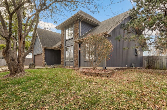 view of front facade with a garage and a front lawn