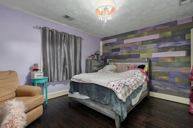 bedroom featuring a textured ceiling and dark wood-type flooring