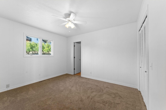 unfurnished bedroom featuring carpet floors, a closet, and ceiling fan