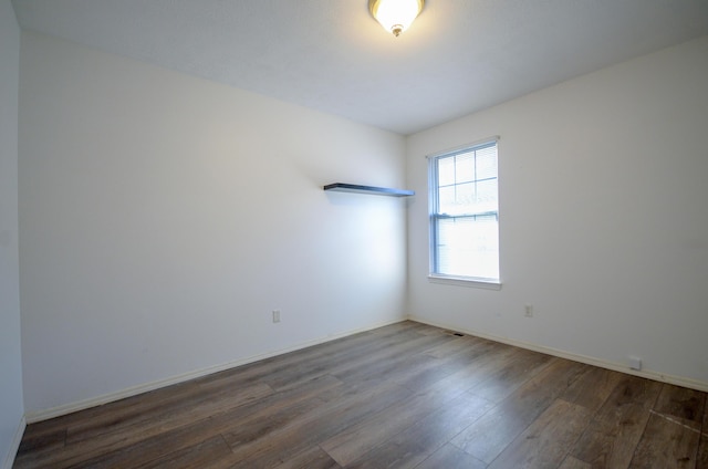 empty room featuring dark hardwood / wood-style flooring