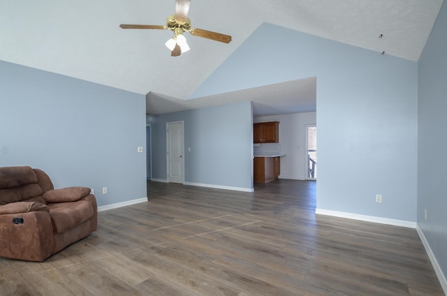 unfurnished living room featuring ceiling fan, high vaulted ceiling, and dark hardwood / wood-style floors