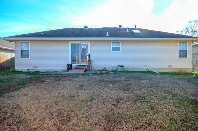 rear view of house with a yard