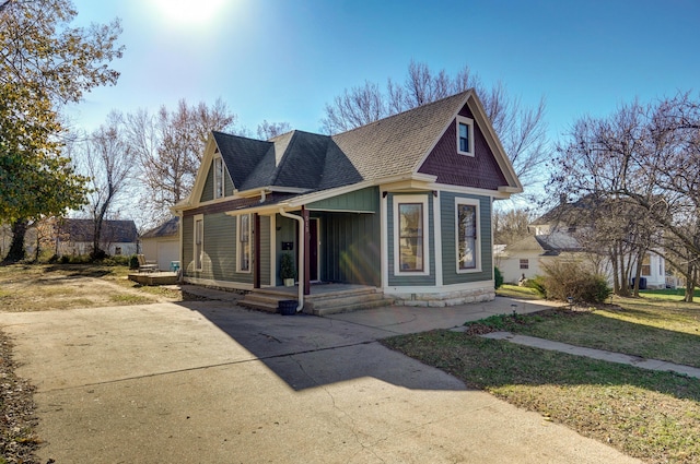 bungalow-style home with a front yard