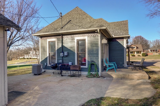 rear view of house with a patio area and central air condition unit