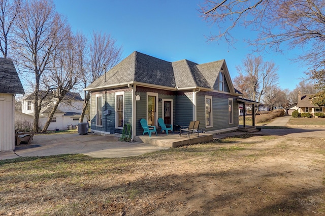 rear view of house with a yard, a patio, and central air condition unit