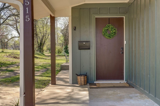 property entrance featuring board and batten siding