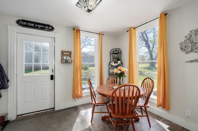 dining space with baseboards and a wealth of natural light