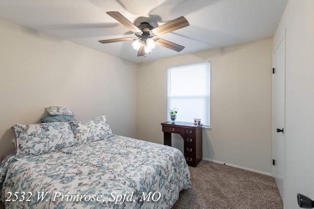 bedroom featuring carpet flooring, a textured ceiling, and ceiling fan