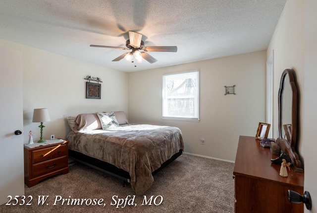 bedroom with ceiling fan, carpet, and a textured ceiling