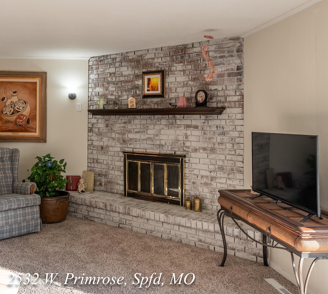 living room featuring carpet flooring, crown molding, and a brick fireplace