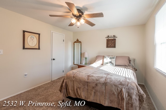 bedroom featuring ceiling fan and carpet