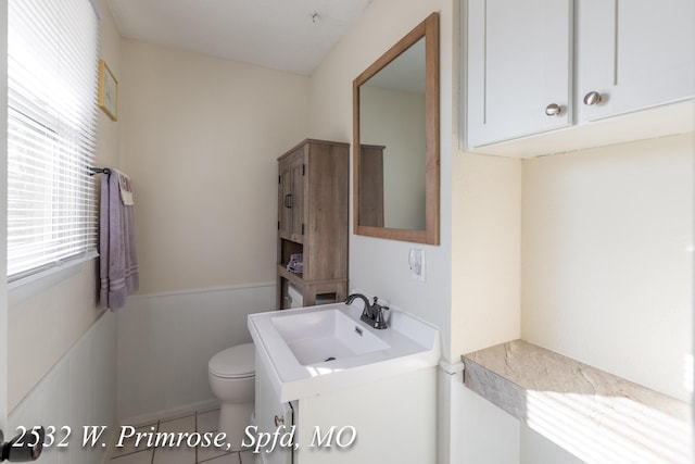 bathroom featuring tile patterned floors, toilet, and sink