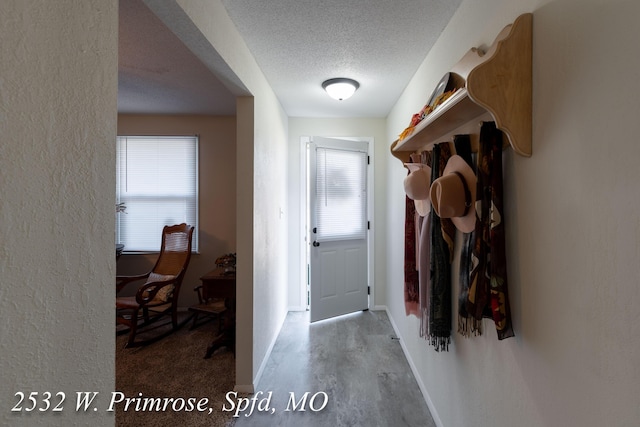 interior space featuring a wealth of natural light and a textured ceiling