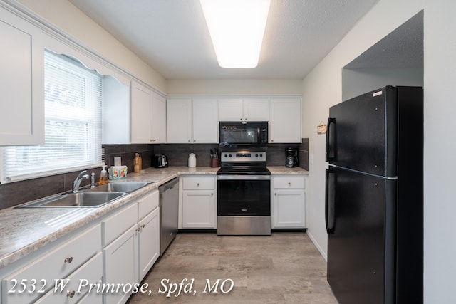 kitchen with white cabinets, sink, backsplash, and black appliances