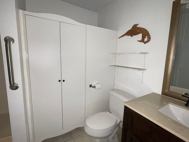 bathroom with tile patterned floors, vanity, and toilet