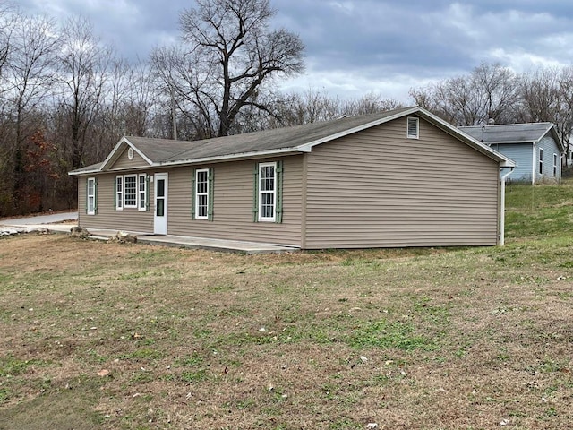 view of side of home with a lawn