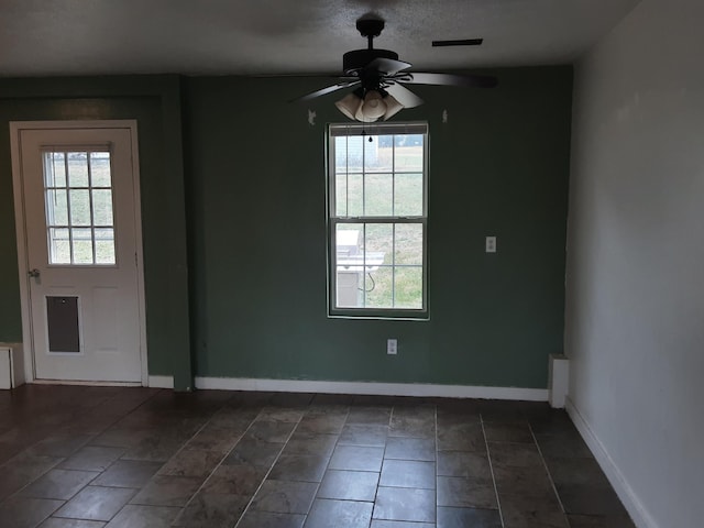 unfurnished dining area featuring ceiling fan