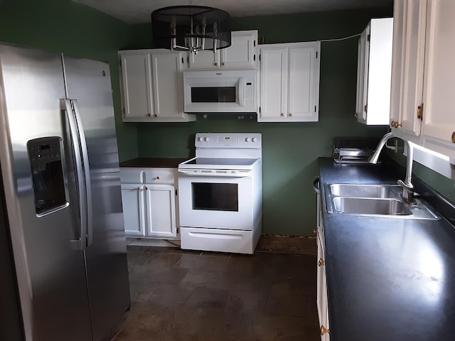 kitchen featuring white cabinetry, sink, a notable chandelier, decorative light fixtures, and white appliances