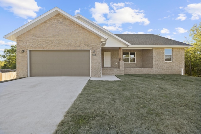 view of front of property with a garage and a front lawn