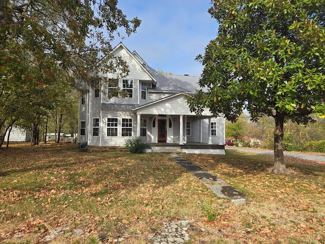 view of front facade featuring covered porch, a front lawn, and central air condition unit