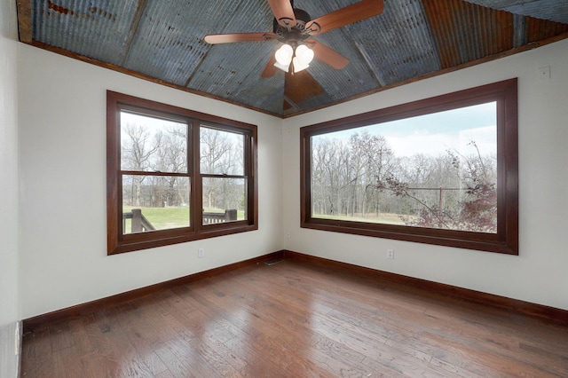 spare room featuring baseboards, ceiling fan, visible vents, and hardwood / wood-style floors